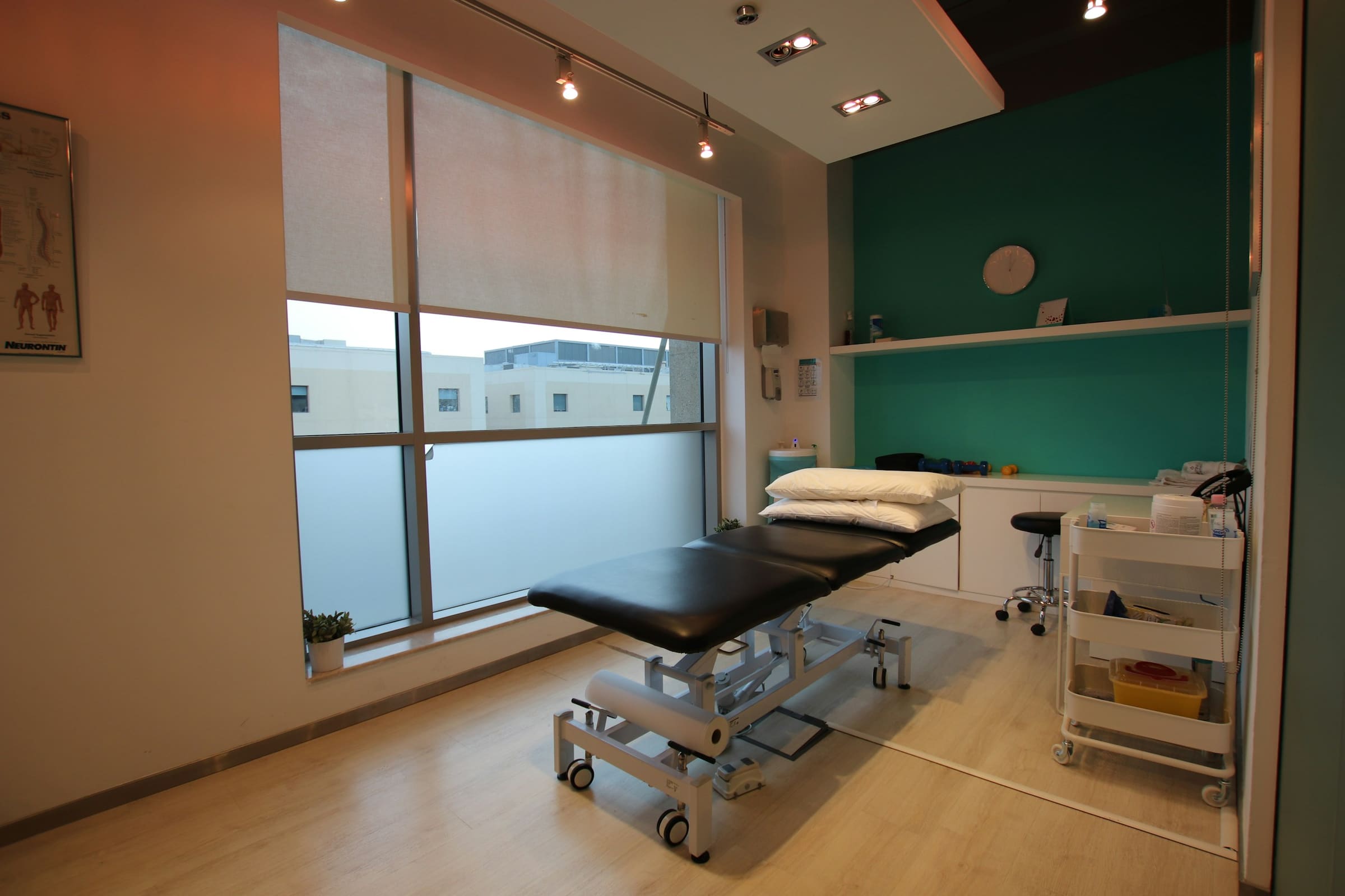An empty treatment couch in a quiet, uncluttered consulting room.